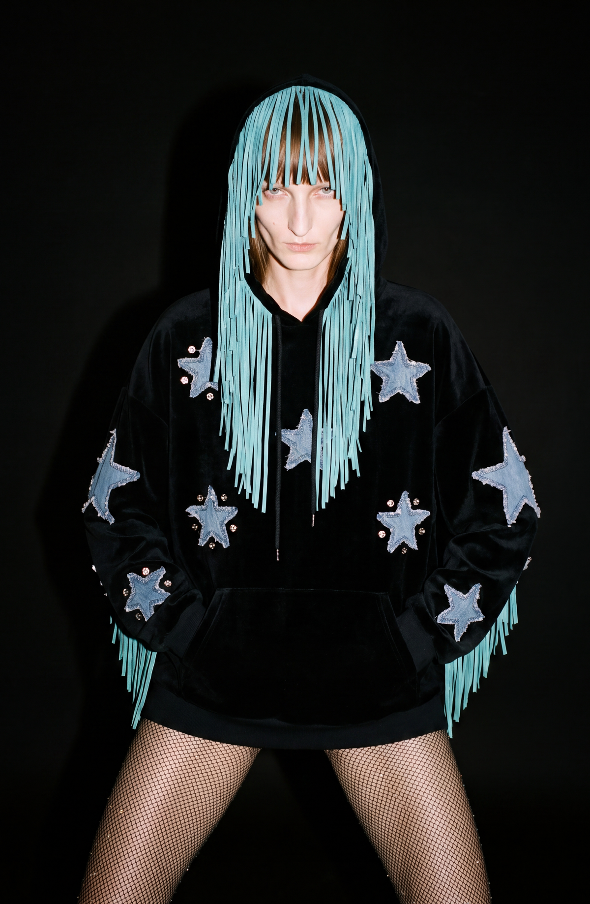 Black velvet hoodie with blue star appliqués and turquoise hood fringe