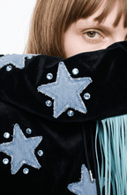 Black velvet hoodie with blue star appliqués and turquoise hood fringe