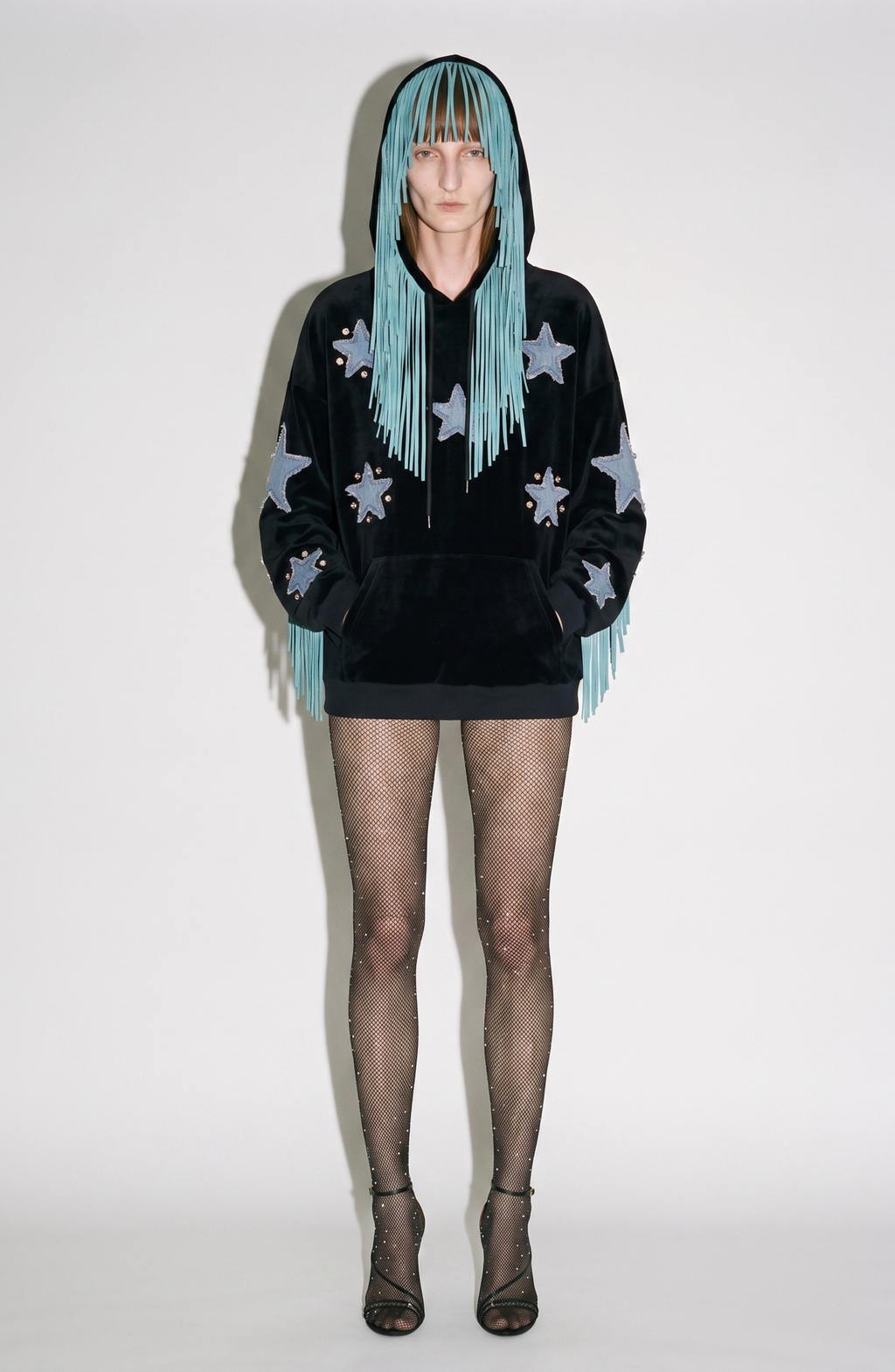 Black velvet hoodie with blue star appliqués and turquoise hood fringe