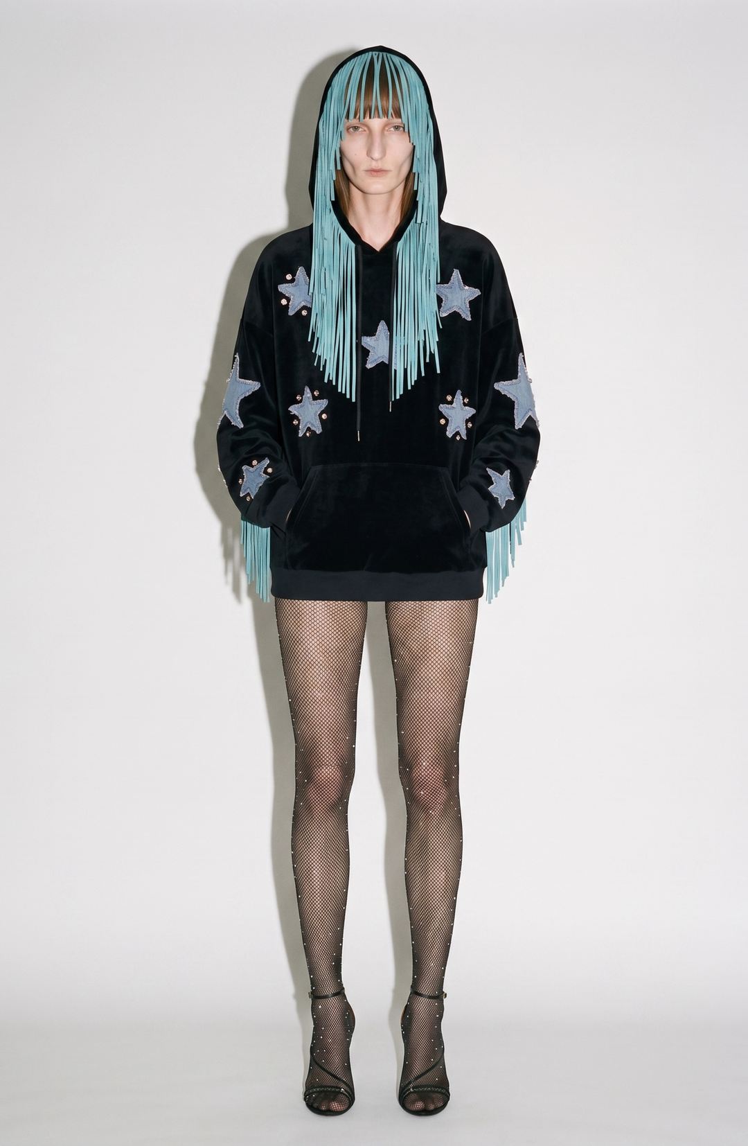 Black velvet hoodie with blue star appliqués and turquoise hood fringe