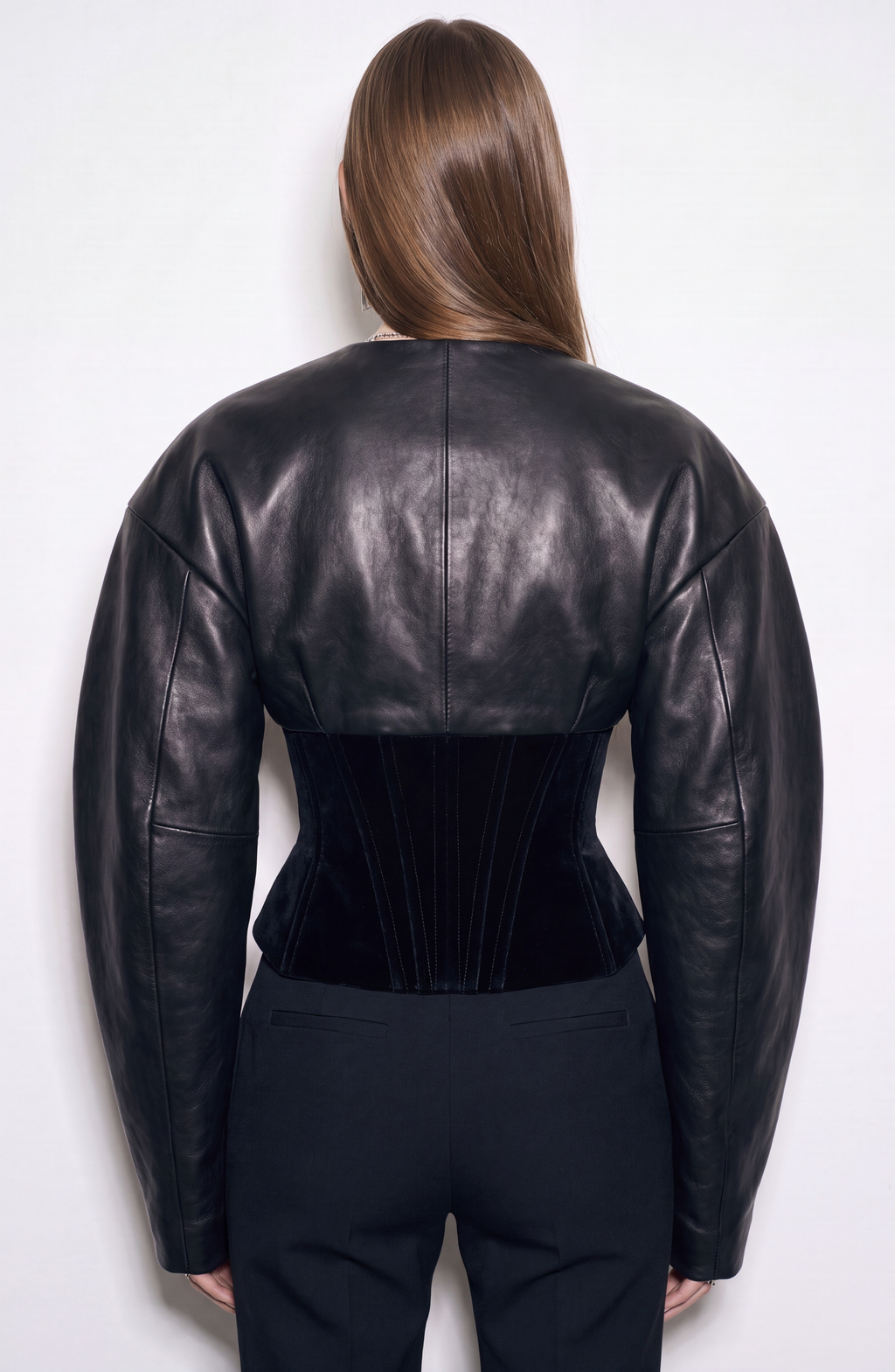 Women's black cropped corset jacket with long sleeves and front zip