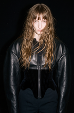 Women's black cropped corset jacket with long sleeves and front zip