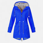 Women's long hooded raincoat with striped lining and zipped pockets