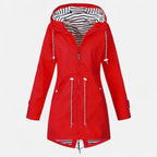 Women's long hooded raincoat with striped lining and zipped pockets