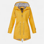 Women's long hooded raincoat with striped lining and zipped pockets