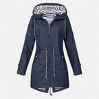 Women's long hooded raincoat with striped lining and zipped pockets