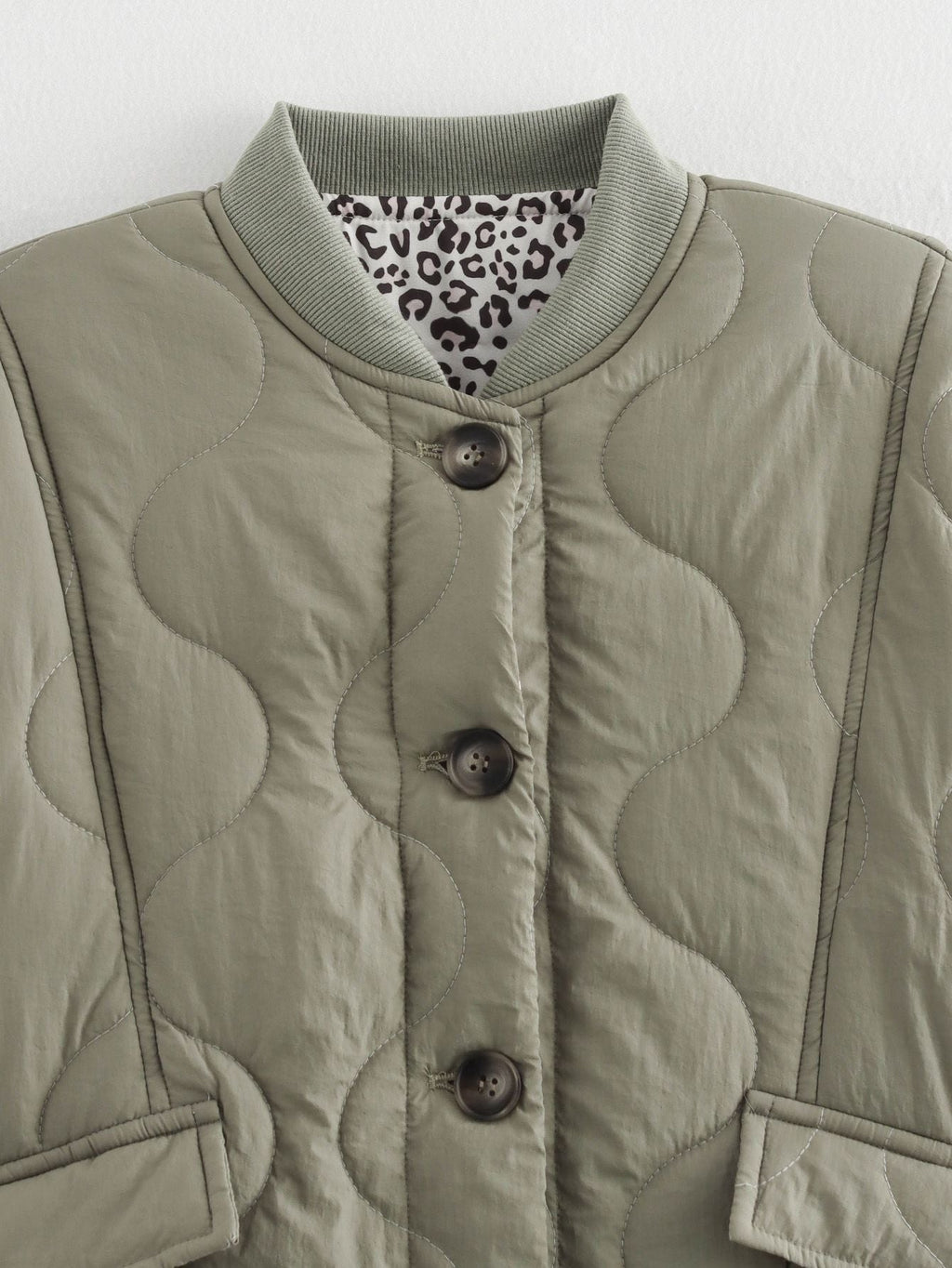 Women's quilted jacket with leopard-print cuffs and button front