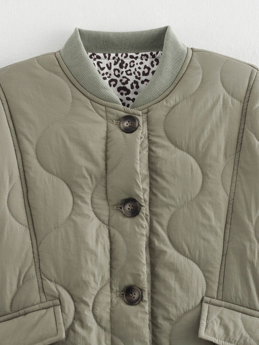 Women's quilted jacket with leopard-print cuffs and button front