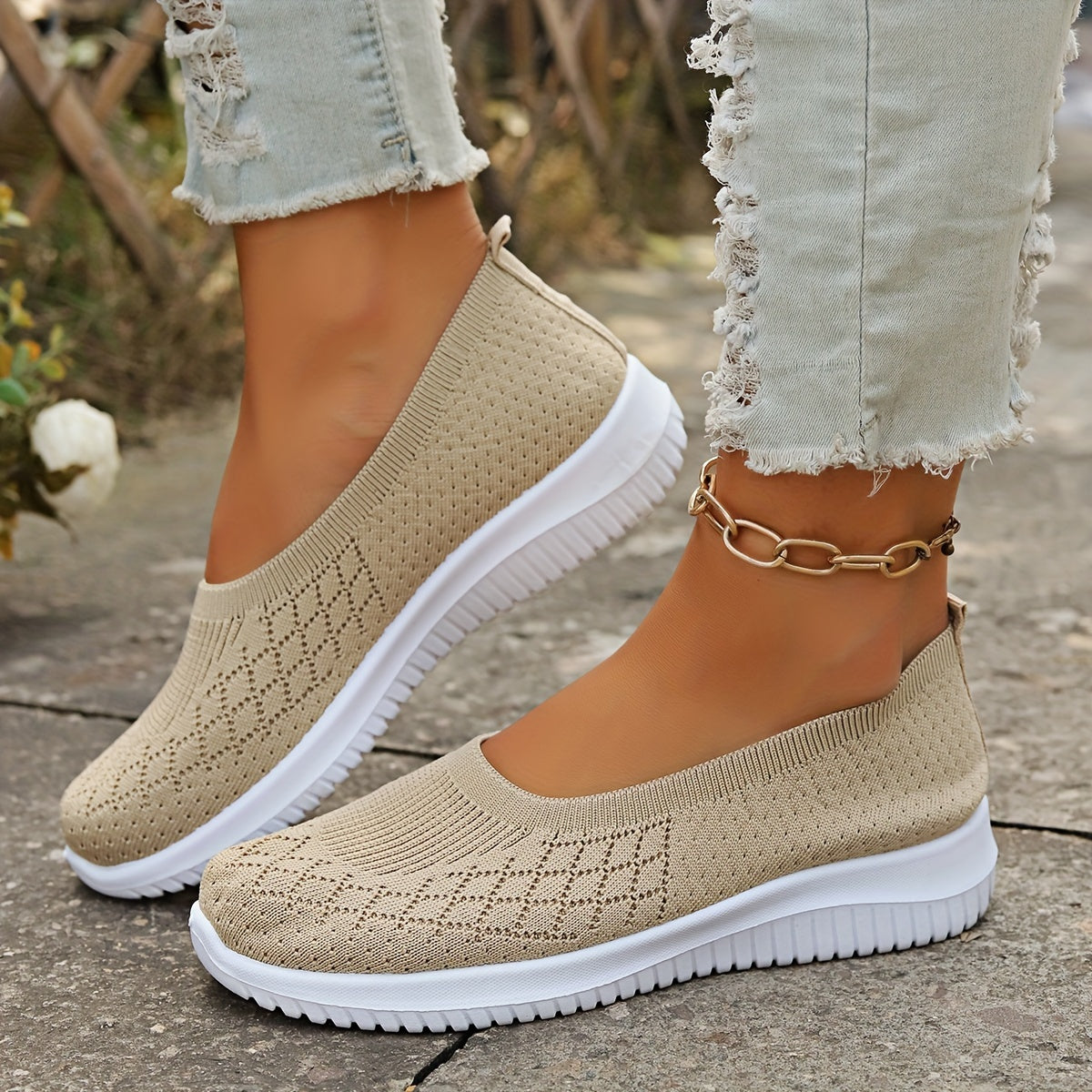 Women's knitted slip-on shoes with closed rounded toe and white ridged sole