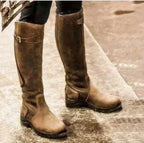 Women's tall winter boots with buckle strap and flat sole