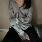 Women's long sleeve collared blouse with button front and curved hem