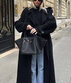 Women's black oversized long coat with lapel collar and button front