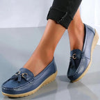 Women's slip-on loafers with round toes, tassel trim and flat textured soles