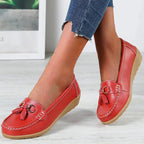 Women's slip-on loafers with round toes, tassel trim and flat textured soles