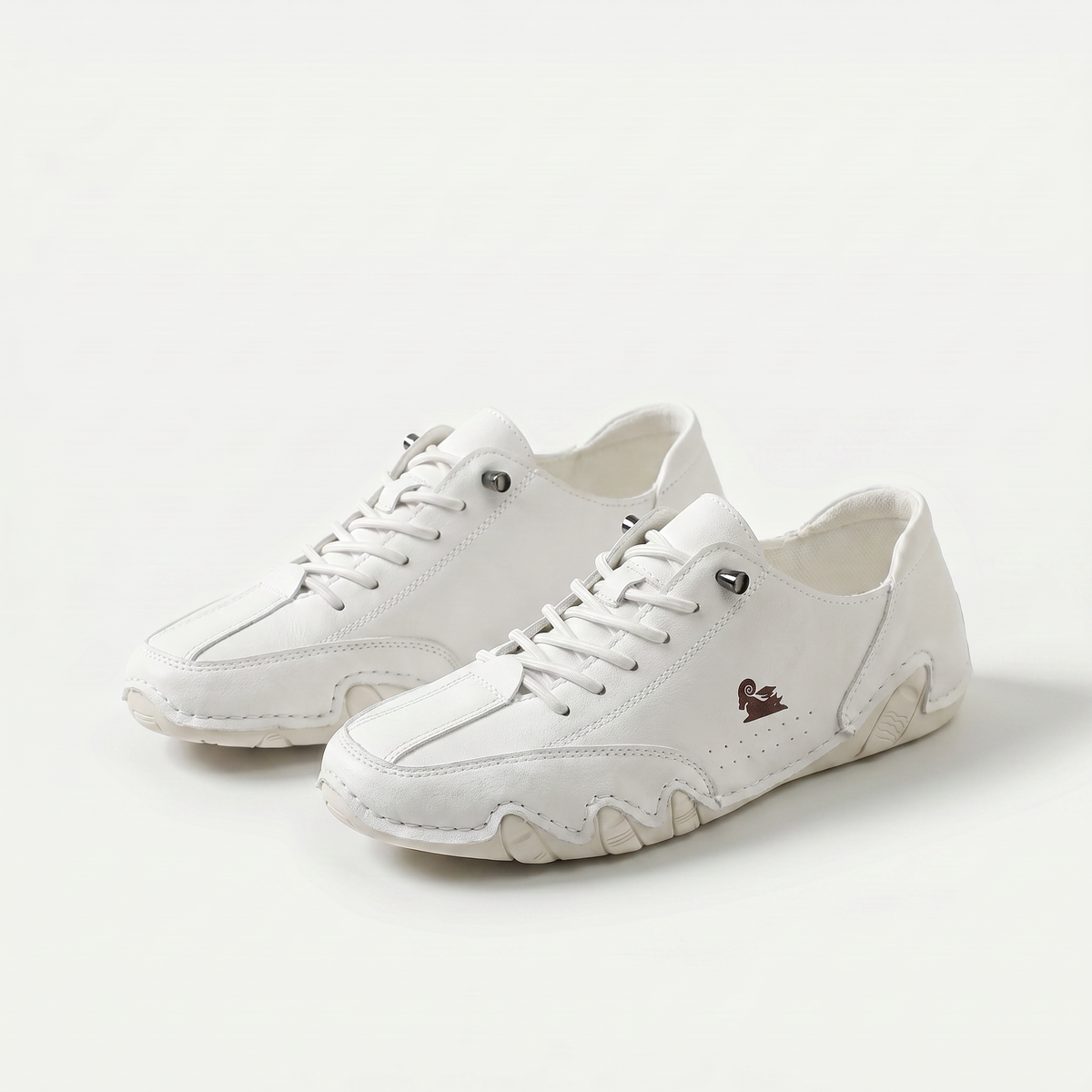 Low-profile lace-up trainers with rounded toes, stitched panels and textured soles