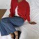 Women's knitted cardigan with round neckline, long sleeves and button front