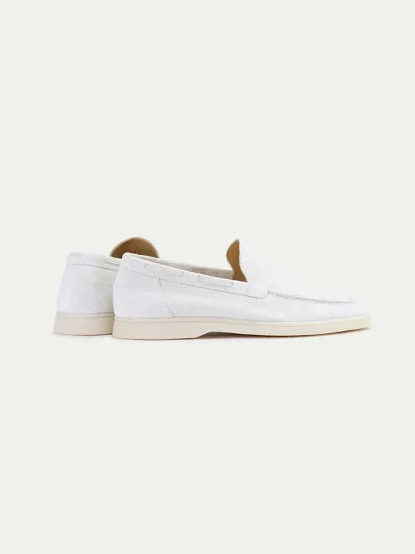 Men's white slip-on loafers with stitched detailing and flat soles