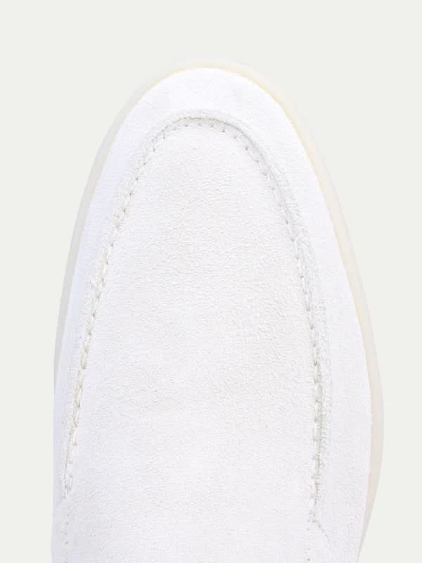 Men's white slip-on loafers with stitched detailing and flat soles