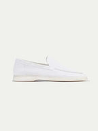 Men's white slip-on loafers with stitched detailing and flat soles