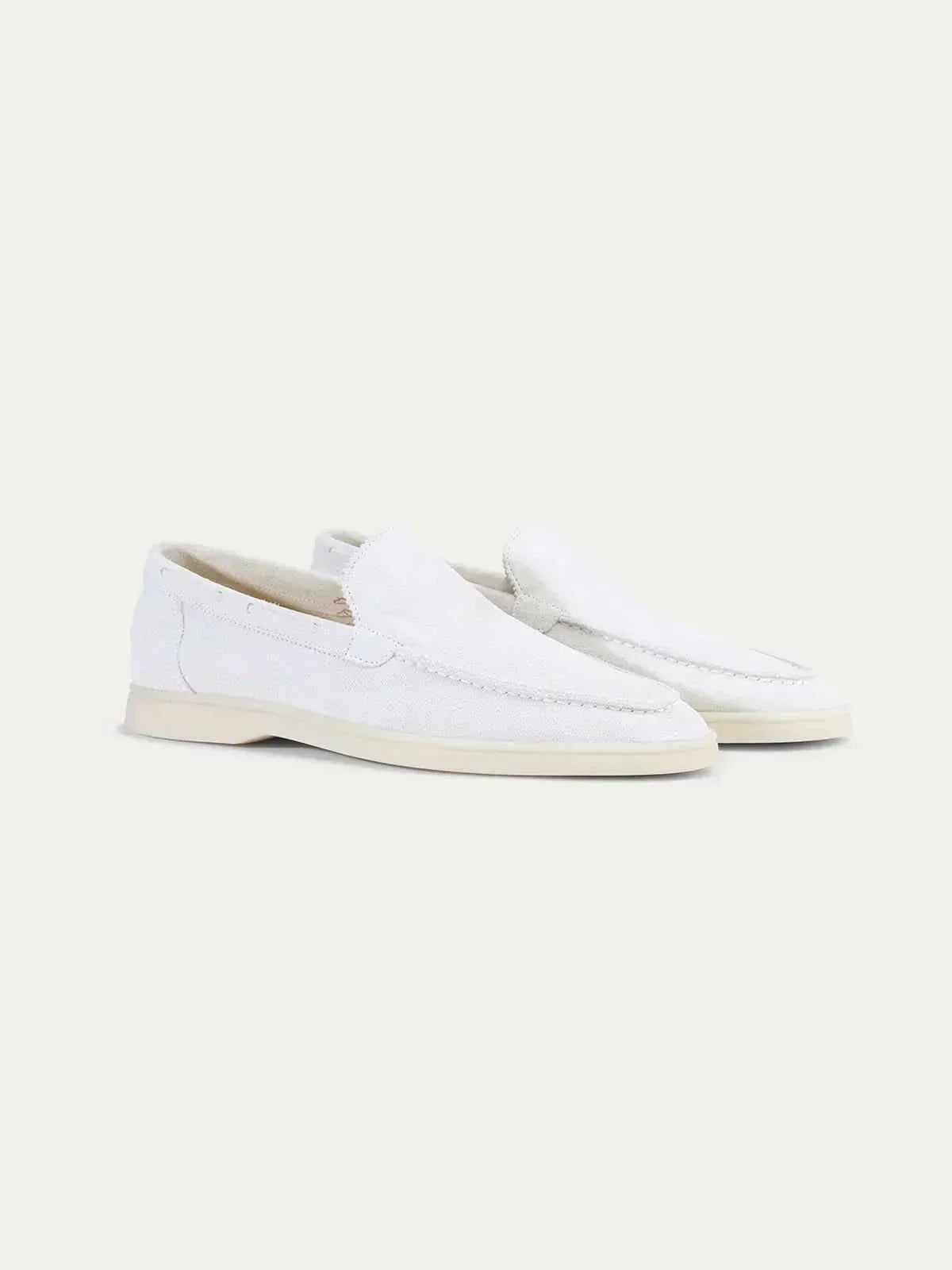Men's white slip-on loafers with stitched detailing and flat soles