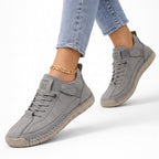 Low-top lace-up sneakers with round toes, side straps and flat textured soles