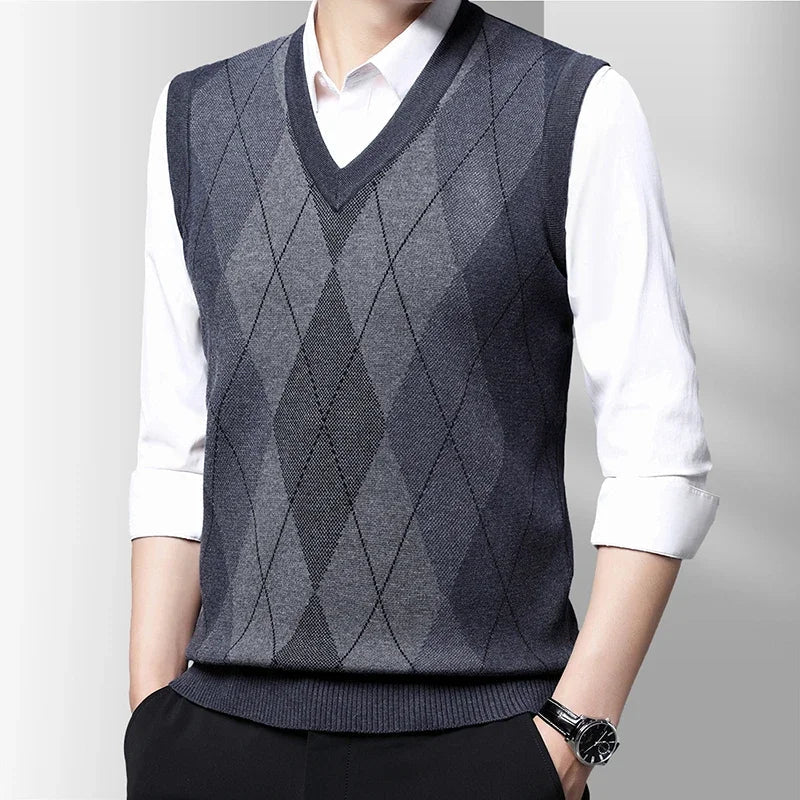 Men's sleeveless argyle V-neck sweater vest layered over a white shirt