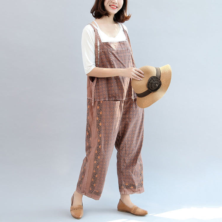 Women's geometric patterned bib jumpsuit with adjustable straps, pockets and cropped wide legs