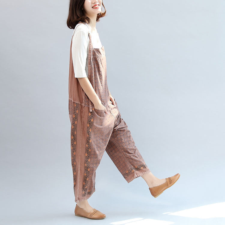 Women's geometric patterned bib jumpsuit with adjustable straps, pockets and cropped wide legs