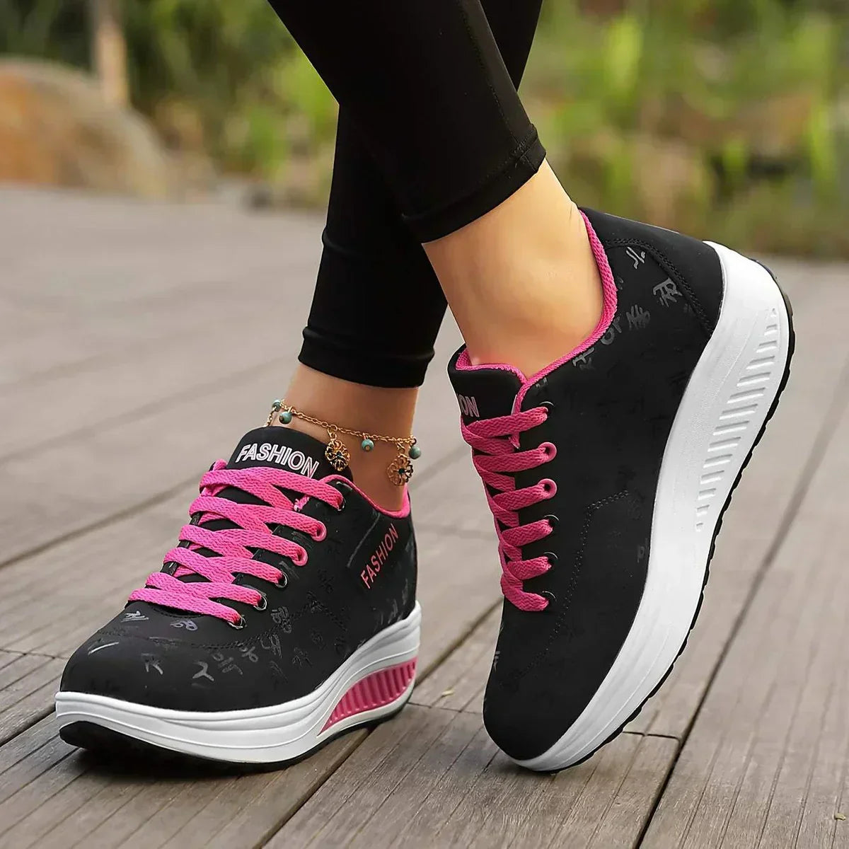 Women's low-top lace-up sneaker with printed symbols, round toe and white sole
