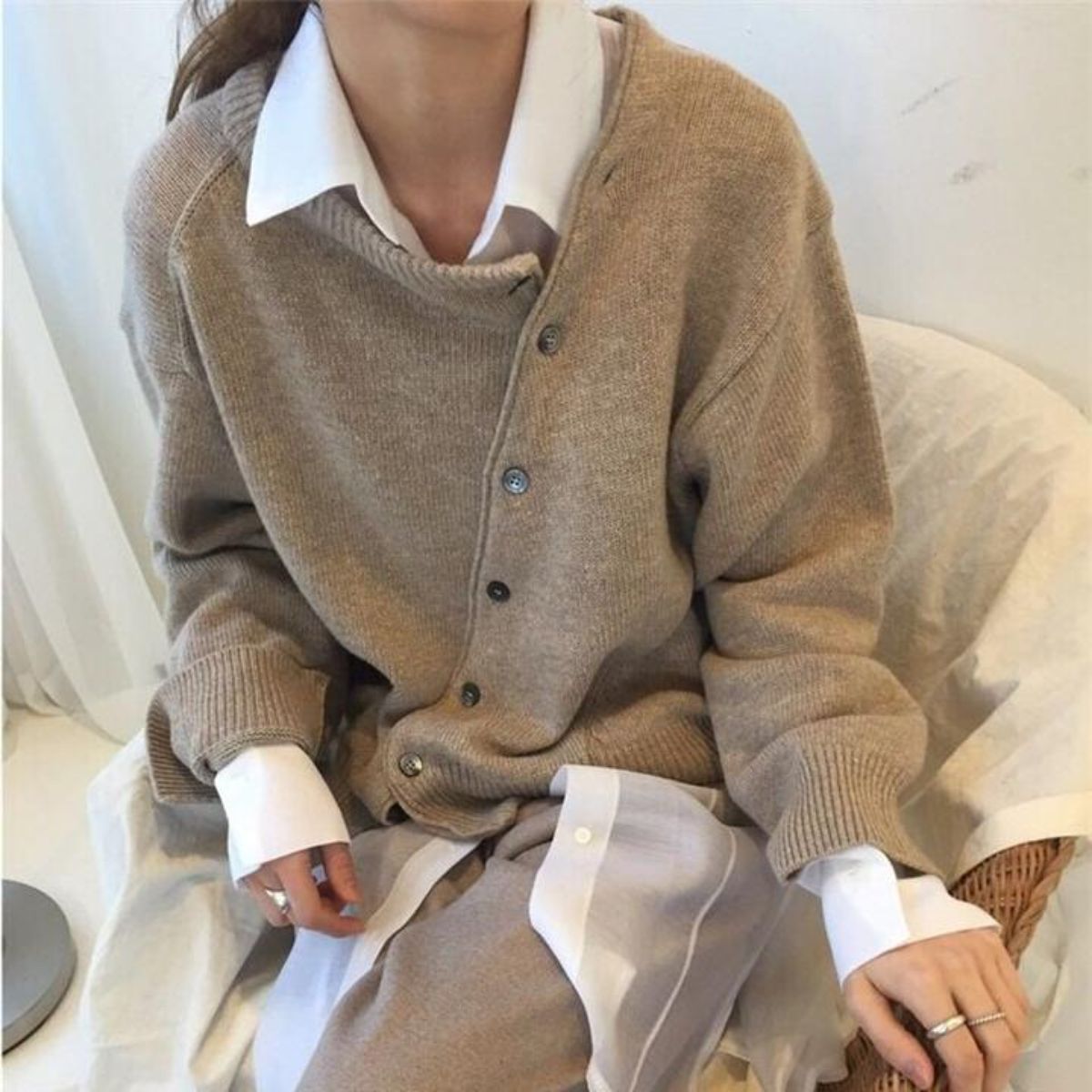 Women's asymmetric knitted cardigan with button front and long sleeves