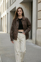 Women's oversized brown faux leather jacket with collar and zip front