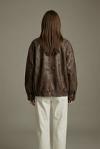 Women's oversized brown faux leather jacket with collar and zip front