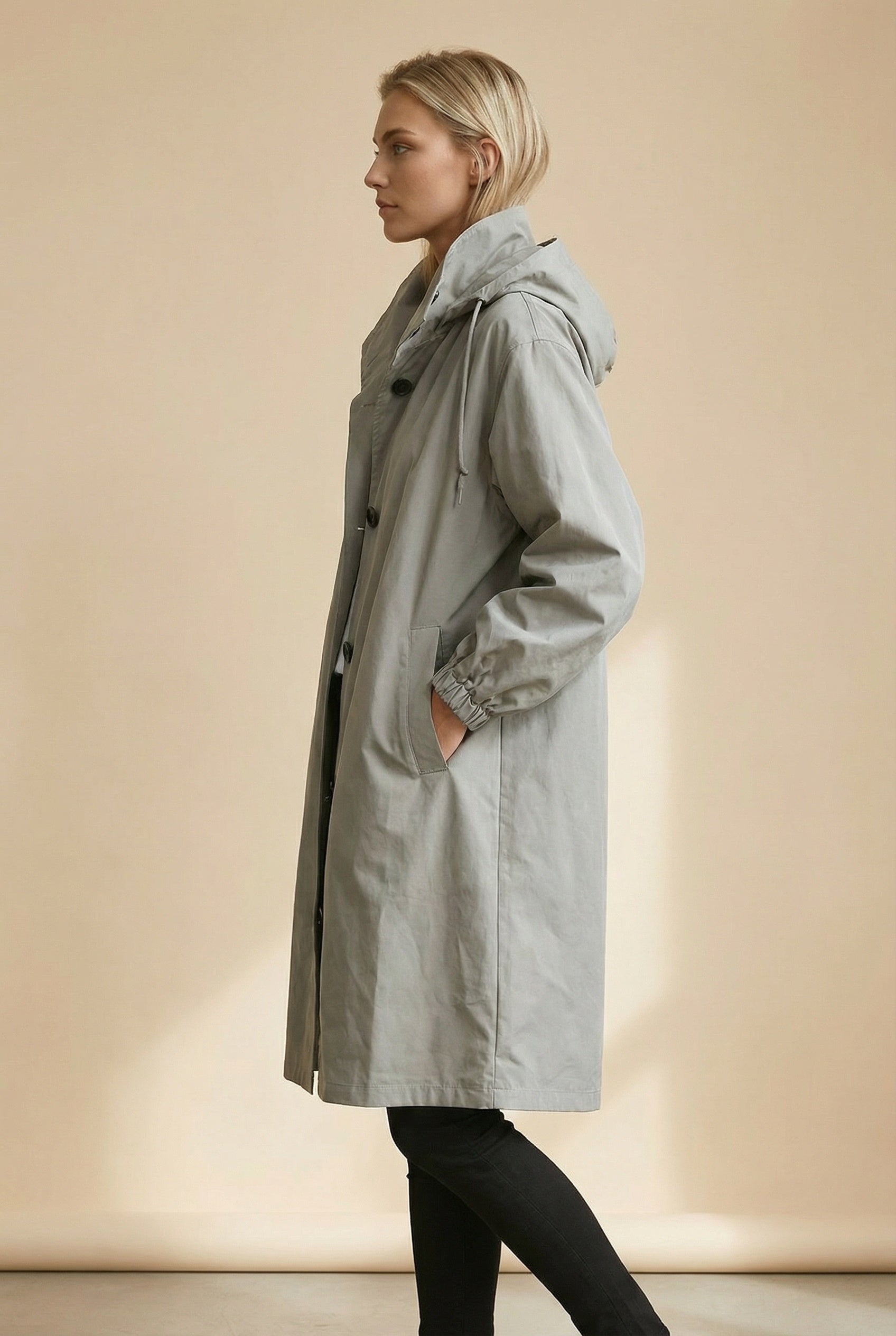 Women's long hooded trench coat with button front and gathered cuffs