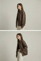 Women's oversized brown faux leather jacket with collar and zip front
