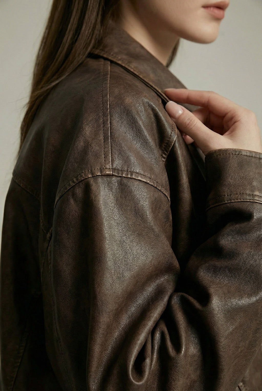 Women's oversized brown faux leather jacket with collar and zip front