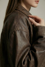 Women's oversized brown faux leather jacket with collar and zip front