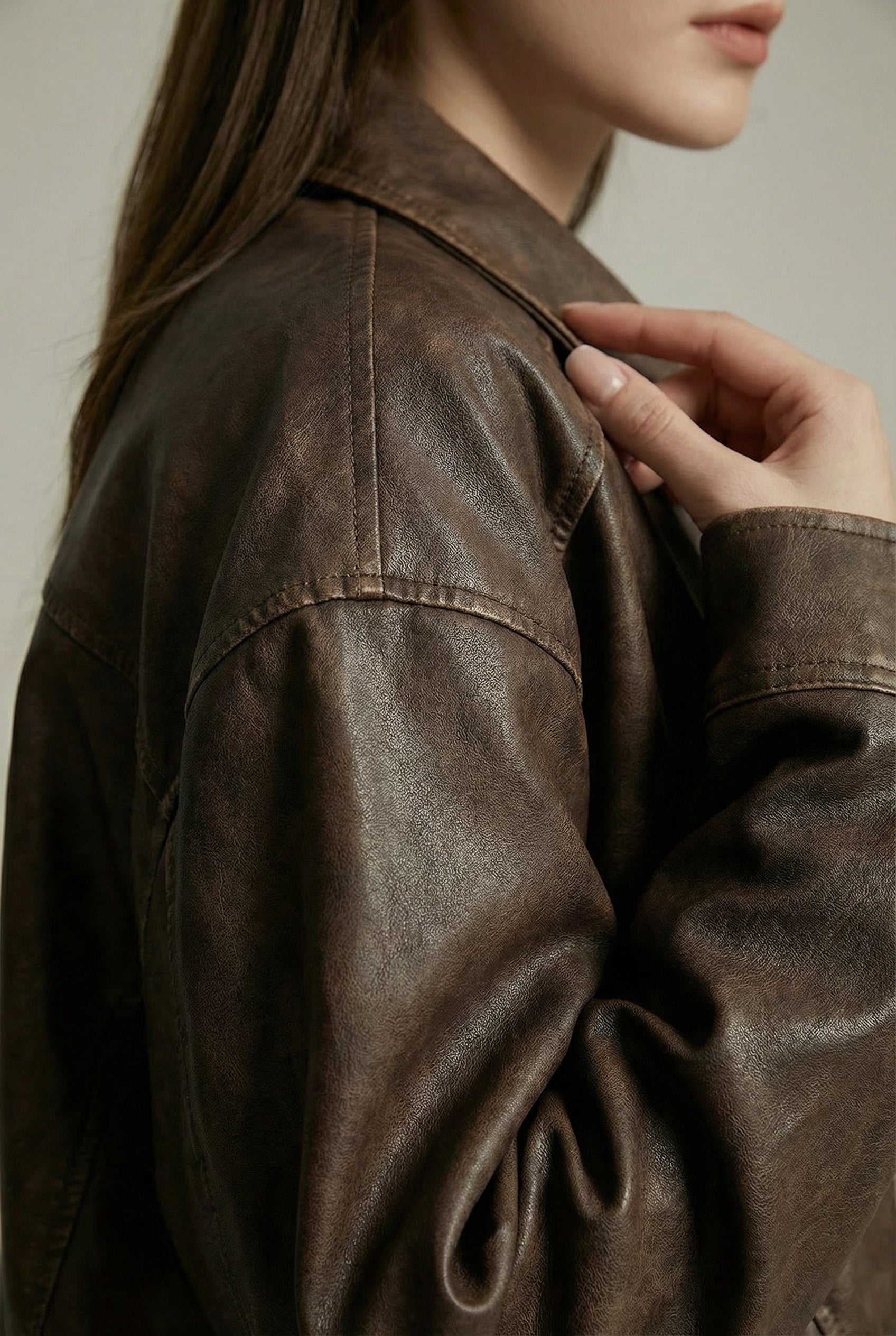 Women's oversized brown faux leather jacket with collar and zip front