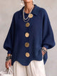 Women's oversized textured cardigan with collared neckline and large metallic buttons