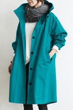 Women's oversized hooded rain parka coat with button front and elastic cuffs