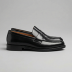 Black men's penny loafers with rounded moc toes and low heels