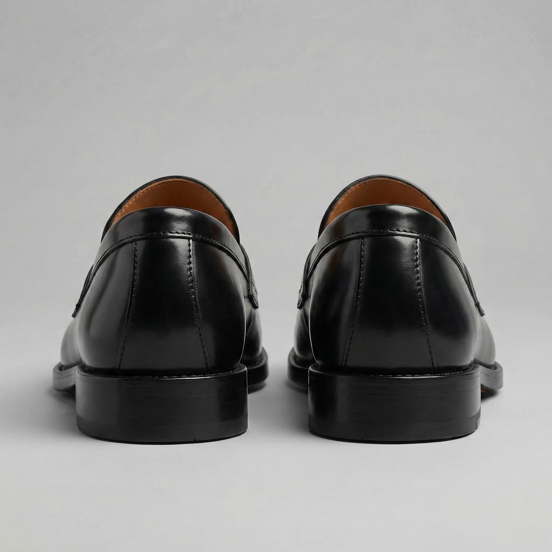 Black men's penny loafers with rounded moc toes and low heels