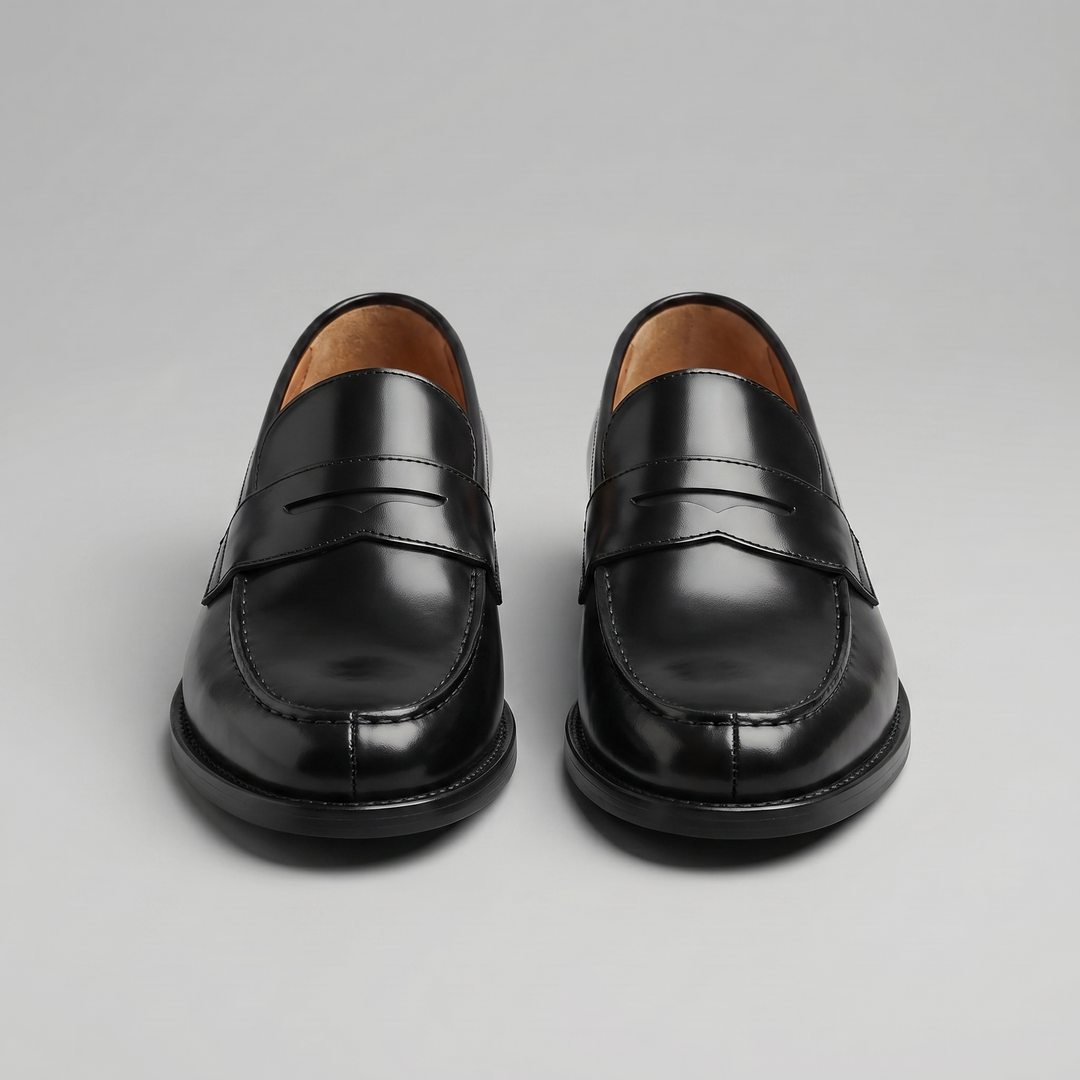 Black men's penny loafers with rounded moc toes and low heels