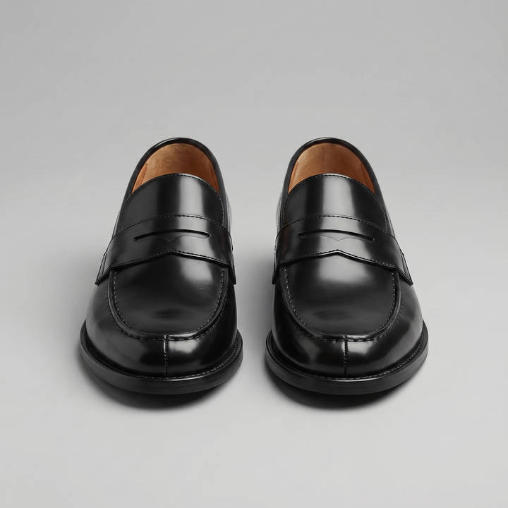 Black men's penny loafers with rounded moc toes and low heels