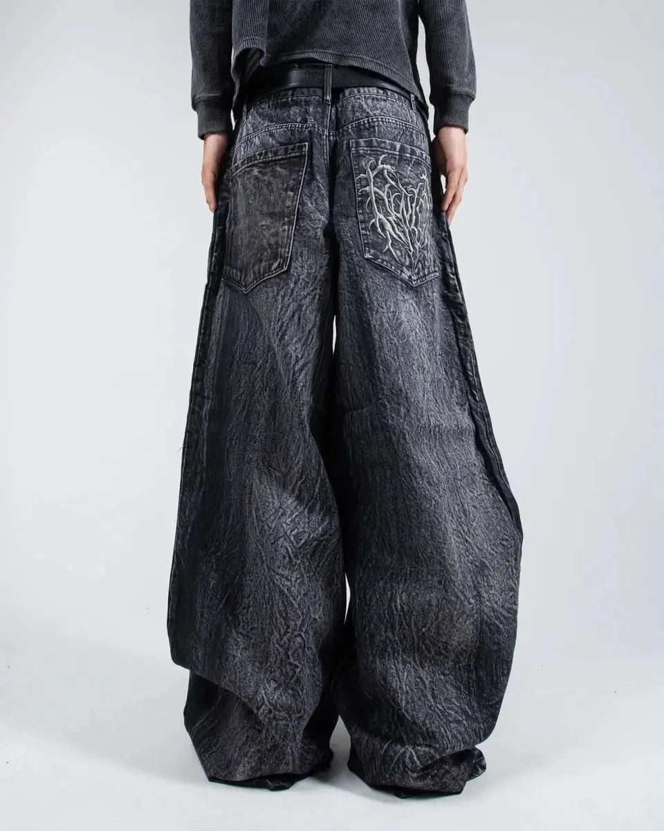 Gray wide leg jeans with frayed spiderweb detailing