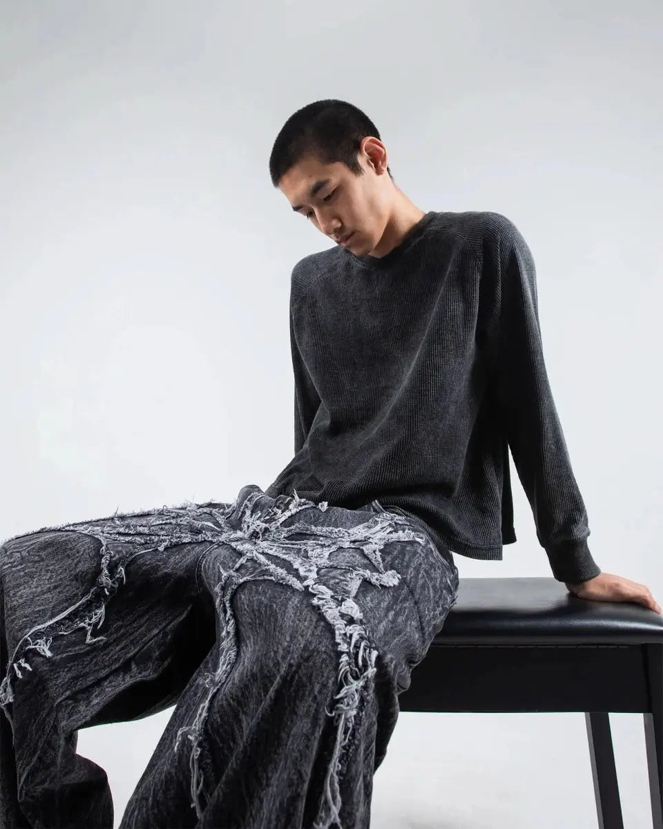 Gray wide leg jeans with frayed spiderweb detailing