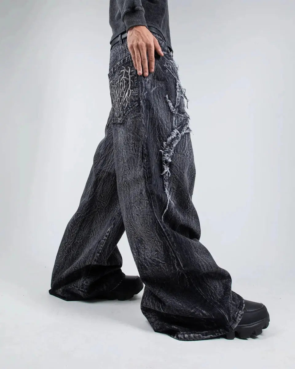 Gray wide leg jeans with frayed spiderweb detailing