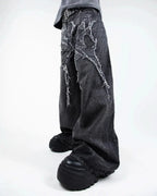 Gray wide leg jeans with frayed spiderweb detailing