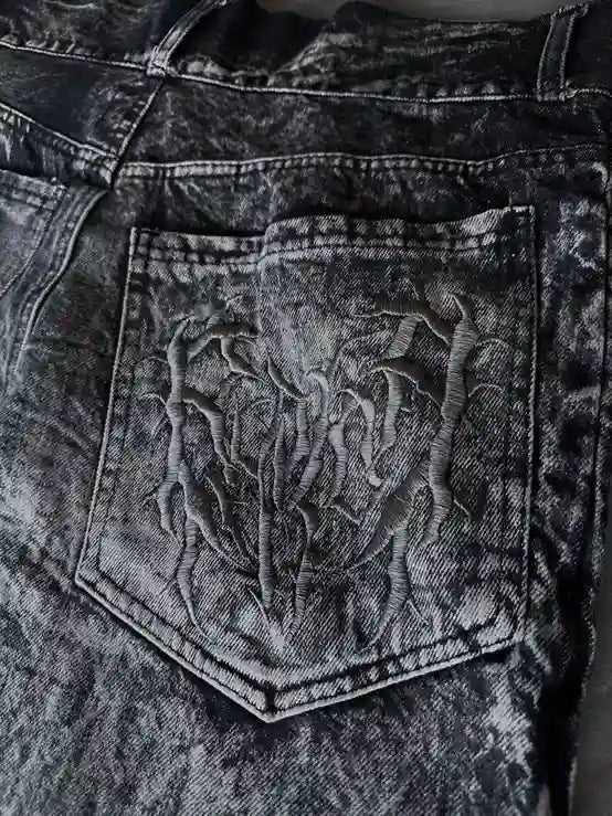 Gray wide leg jeans with frayed spiderweb detailing