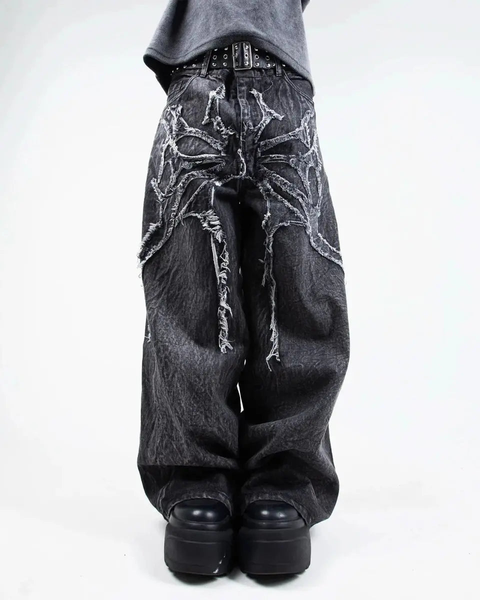 Gray wide leg jeans with frayed spiderweb detailing