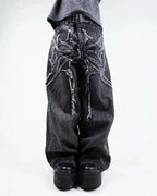 Gray wide leg jeans with frayed spiderweb detailing